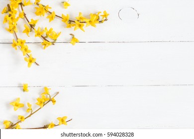 Flowers composition. Frame made of yellow flowers on wooden white background. Easter, spring, summer concept. Flat lay, top view