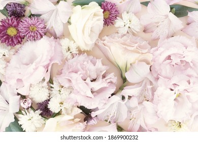 Flowers composition macro background made of eustoma and daisy flowers. Flat lay, top view scene, toned