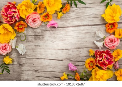 Flowers composition on wooden background with spring flowers. Easter concept with copy spase. Flat lay, top view.