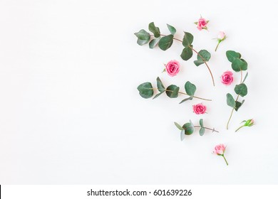 Flowers composition. Rose flowers and eucalyptus branches on white background. Flat lay, top view, copy space. - Shutterstock ID 601639226