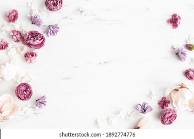 Flowers composition. White and purple flowers on marble background. Flat lay, top view - Shutterstock ID 1892774776