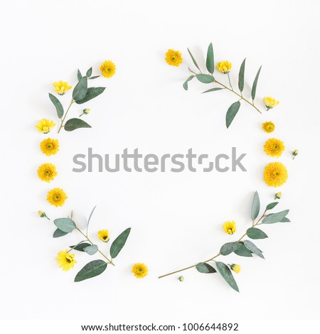 Flowers composition. Wreath made of various yellow flowers and eucalyptus branches on white background. Flat lay, top view, copy space, square.