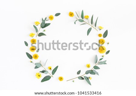 Flowers composition. Wreath made of various yellow flowers and eucalyptus branches on white background. Flat lay, top view, copy space