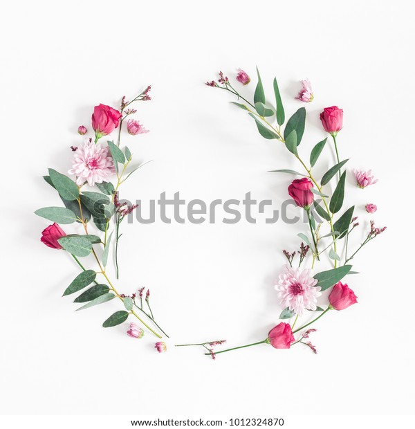 Flowers composition. Wreath made of various pink\
flowers and eucalyptus branches on white background. Flat lay, top\
view, copy space,\
square.