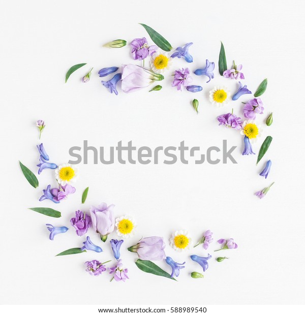 Flowers composition. Wreath made of various\
colorful flowers on white background. Easter, spring, summer\
concept. Flat lay, top view, copy\
space