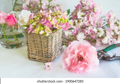 Flowers Decorations Making. Various Roses, Basket, Vase And Vintage Shears On White Background