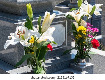 Flowers displayed in flower stands and Japanese graves. - Shutterstock ID 2183169135