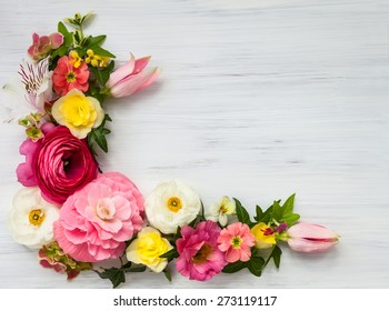 Flowers frame on white wooden background. Top view with copy space - Powered by Shutterstock