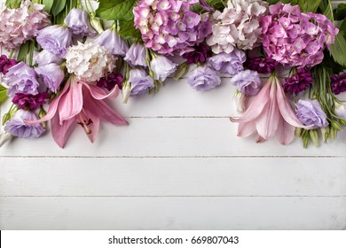 Flowers Frame On White Wooden Background. Top View With Copy Space