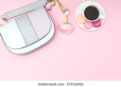 flowers, handbag and coffee on pink background.