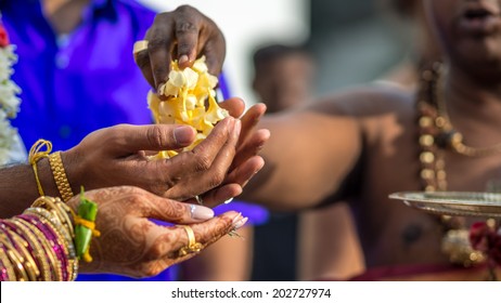 Flowers Are Handed From The Hindu Priest To The Wedding Couple During A South Indian Wedding