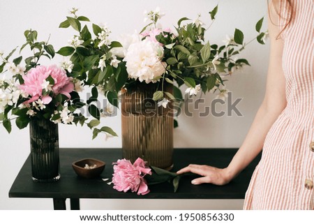 Similar – Woman holding vase with flowers