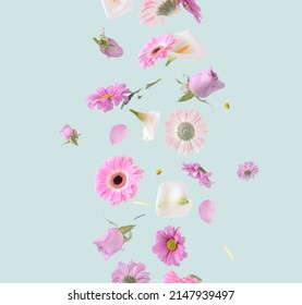 Flowers levitating on a pastel green background. Colorful pink, white and purple trendy summer flowers flying. Surreal aesthetic nature concept. - Shutterstock ID 2147939497