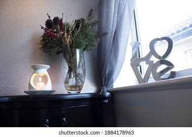 Flowers For Love And A Single Lit Candle