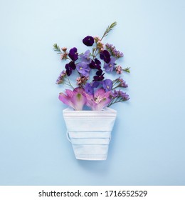 Flowers With Mask On Blue Background. Happy Nurse Day Concept. Top View