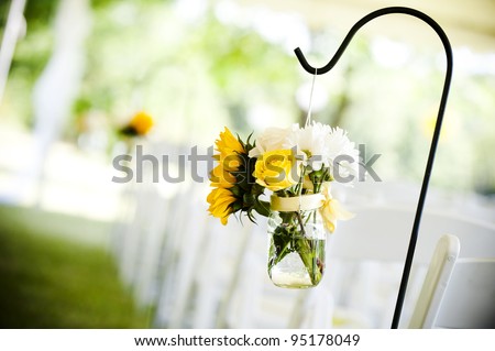 flowers in a mason jar at a wedding ceremony