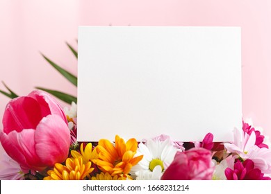 Flowers Mock Up Congratulation. Congratulations Card In Bouquet Of Flowers On Pink Background. White Blank Card With Space For Text, Frame Mockup. Spring Festive Flower Concept, Gift Card.