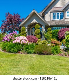 Flowers, Nicely Trimmed Bushes In Front Of The House, Front Yard. Landscape Design.