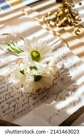 Flowers And Old Handwritten Letter On The Table With Beautiful Sun Light