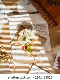 Flowers And Old Handwritten Letter On The Table With Beautiful Sun Light