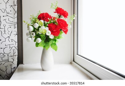 Flowers On A Window Sill.