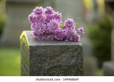 Flowers rest on headstone in cemetery