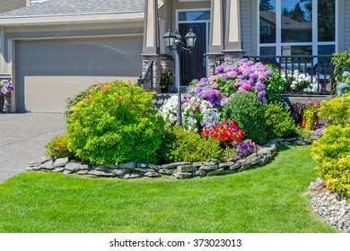 Flowers And Stones In Front Of The House, Front Yard. Landscape Design.