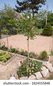 Flowers And Stones In The Garden. Palisade In The Garden.