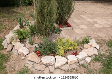 Flowers And Stones In The Garden. Palisade In The Garden.