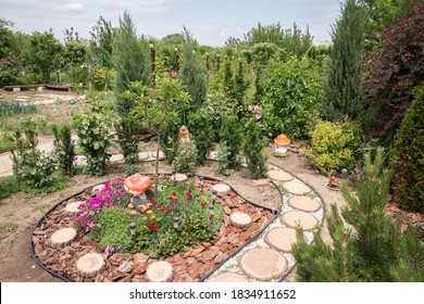 Flowers And Stones In The Garden. Palisade In The Garden.