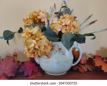 Flowers In A Vase For Autumn Decorations On Top Of A Mantle.