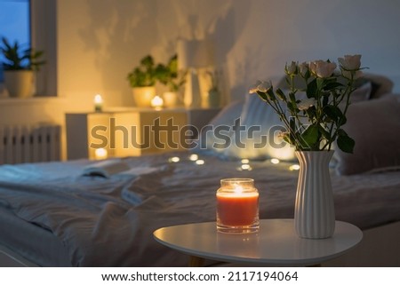 flowers in vase in bedroom in evening