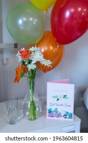 Flowers In Vase, Get Well Card And Balloons On Bedside Table In Children's Ward At A Hospital. Medicine, Health And Healthcare Services.