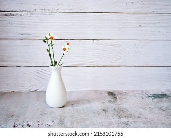 Flowers in vase on table vintage background ,Black jack ,copy space for letter ,daisy flower in white vase old wall for wallpaper or text message writing ,black and white, gray color, Bidens pilosa
