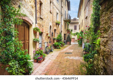 Flowery streets on a rainy spring day in a small magical village Pienza, Tuscany.