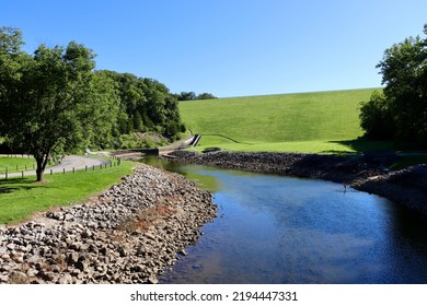 The Flowing Brook In The Countryside Valley On A Sunny Day.