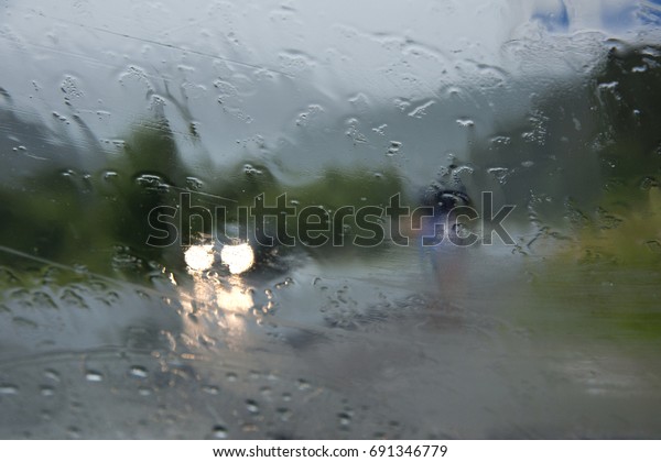 Flowing down drops of rain on glass,macro rain\
drops on the glass