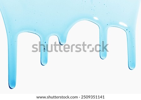 Flowing transparent blue liquid on a light background. Cosmetics, shampoo, serum, snail slime.