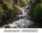 Flowing water of cascade waterfall in deep tropical forest at hot summer day, waterfall in the mountains, mountain river, river from a glacier