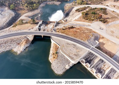 Flowing Water And Spillway Of Jindabyne Lake Dam On Snowy River In The Snowy Mountains Of AUstralia - Aerial Top Down View.