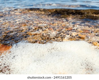 Flowing wave on the sea sandy beach at sunset. Summer vacation background and coastal nature concept. wave water and rocks near the shore. Wave on sea surface. Natural background. - Powered by Shutterstock