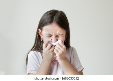 Flu Concept - Upset And Sick Child Blowing His Nose With Flu Symptoms Coughing At Home, Allergic Girl, Flu Season. Girl With Cold Rhinitis, Cold