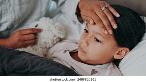 Flu, fever and mother with sick girl for health, virus or infection symptoms in bedroom. Family, childcare and hands of parent with child at home in bed to check temperature for cold, illness and flu - Powered by Shutterstock