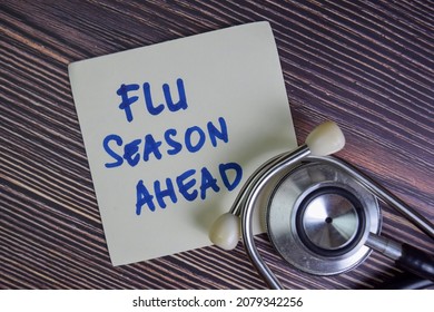 Flu Season Ahead Write On Sticky Notes Isolated On Wooden Table.