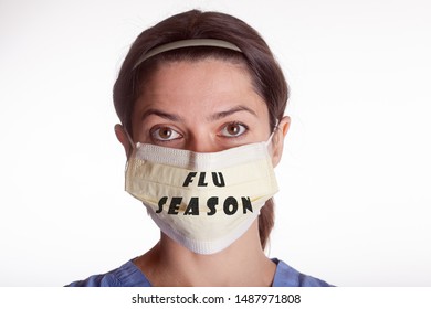 Flu Season Written On Female Nurses Mask On A White Seamless Background