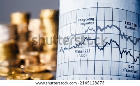 Fluctuating prices of Nikkei, Hang Seng, Dax, and FTSE with stacks of money in the background as a symbol for turbulent times on the stock exchange