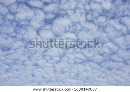 Fluffly clouds and clear sky.