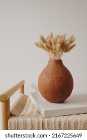 Fluffy Bunny Tail Grass Bouquet In Elegant Clay Pot On Rattan Bench. Aesthetic Minimal Modern Scandinavian Interior Design Decoration