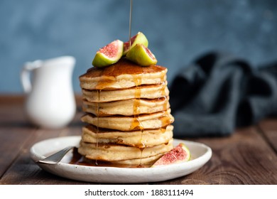 Fluffy Buttermilk Pancakes With Figs And Syrup Pouring Over. Delicious Appetizing Stack Of Thick Pancakes