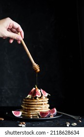 Fluffy Buttermilk Pancakes With Figs And Syrup Pouring Over